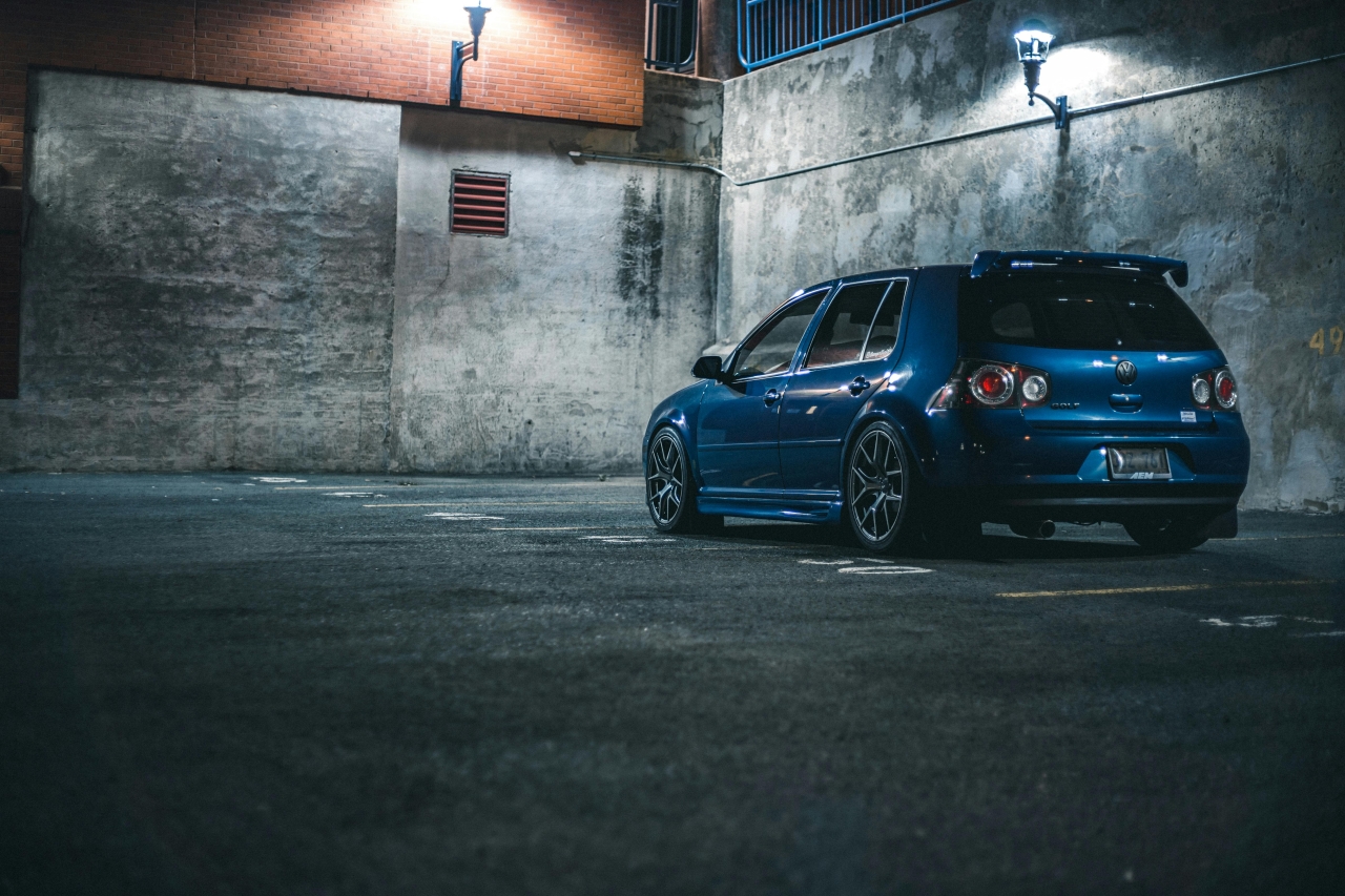 Volkswagen – niebieski hatchback (np. Golf), ujęcie tylne 3/4 na parkingu; przykład modernizacji na używanych częściach