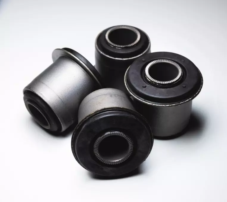 Suspension bushings and chassis components for vibration and noise reduction
